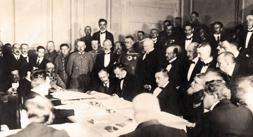 The Ukrainian delegation signs the peace protocol during negotiations at Brest-Litovsk, 9 February 1918. Photo credit: DPA / Picture Alliance via Reuters Connect.